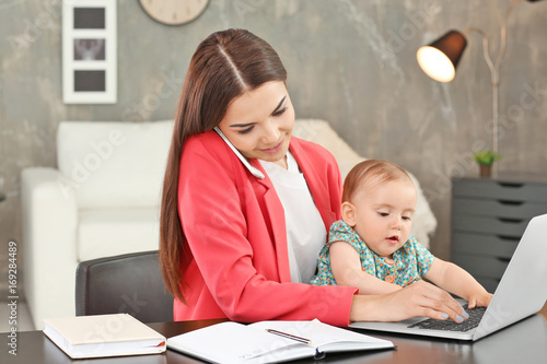 Young mother holding baby w...