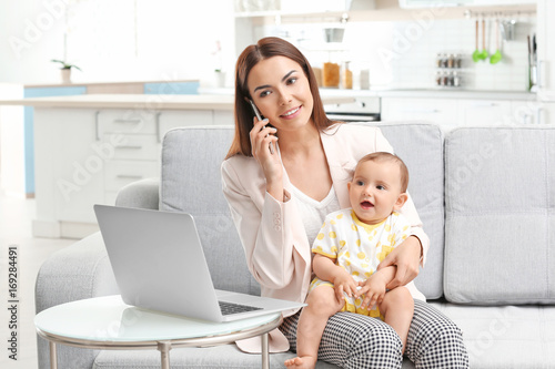 Young mother holding baby w...