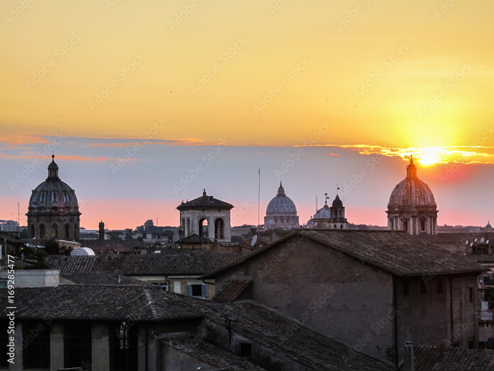 Sunset and Rome's cityscape with church domes