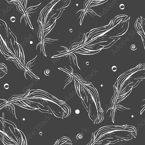 Seamless pattern white hand-drawn feathers on a dark grey background. Vector photo