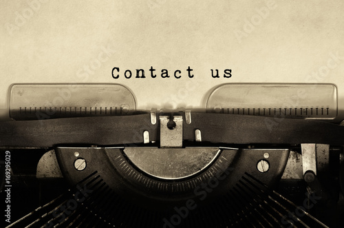 Contact us words typed on vintage typewriter.