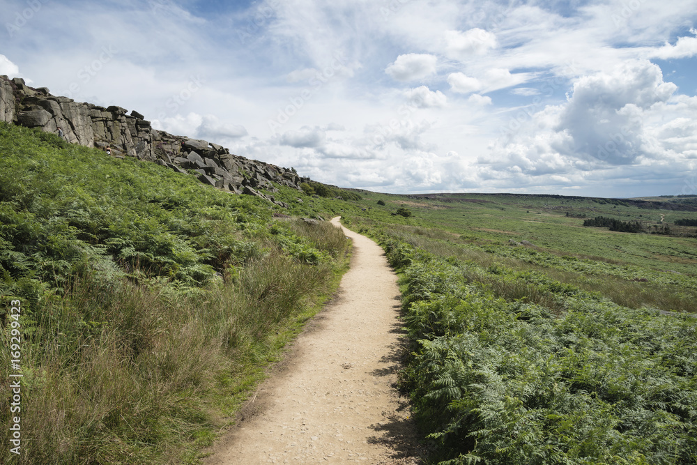 Beautiful vibrant landscape image of Burbage Edge and Rocks in Summer in Peak District England