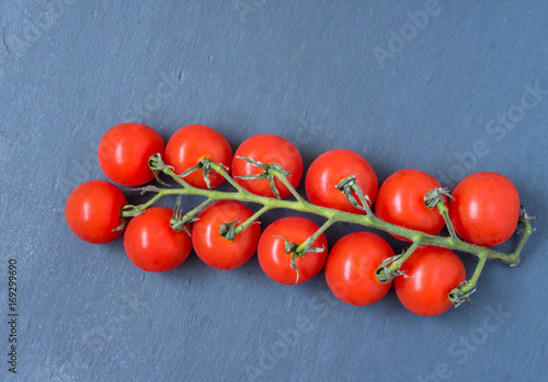 Cherry Tomatoes, black granite background, top view