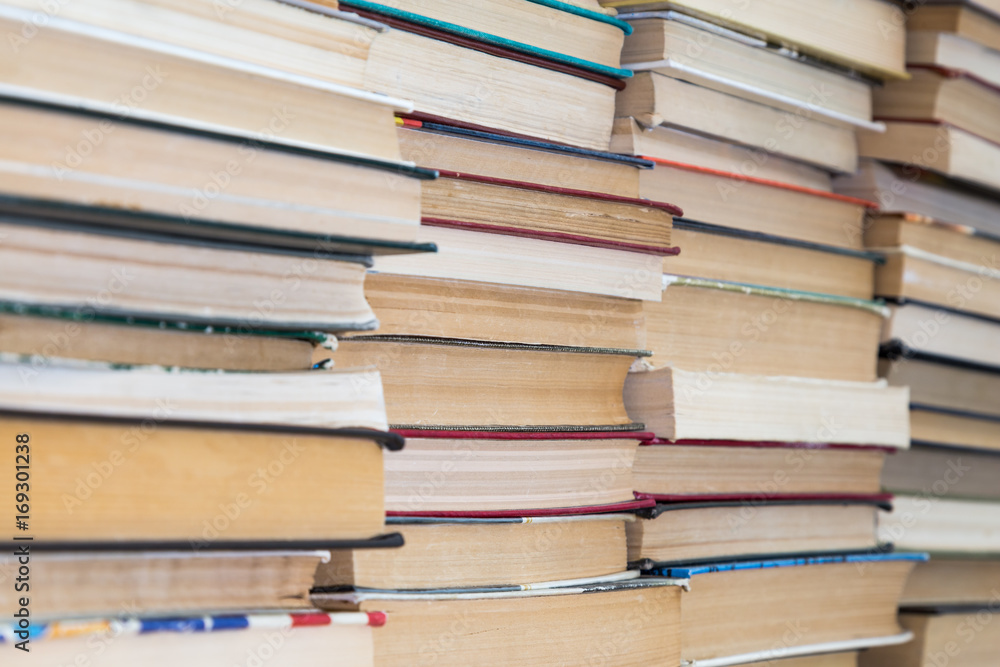 A stack of books with colorful covers. The library or bookstore. Books or textbooks. Education and reading. A stack of books with colorful covers. The library or bookstore. Books or textbooks. Education and reading.
