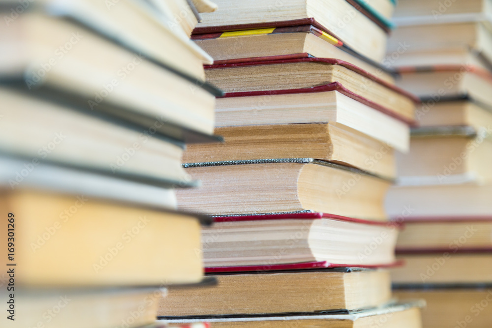 A stack of books with colorful covers. The library or bookstore. Books or textbooks. Education and reading. A stack of books with colorful covers. The library or bookstore. Books or textbooks. Education and reading.
