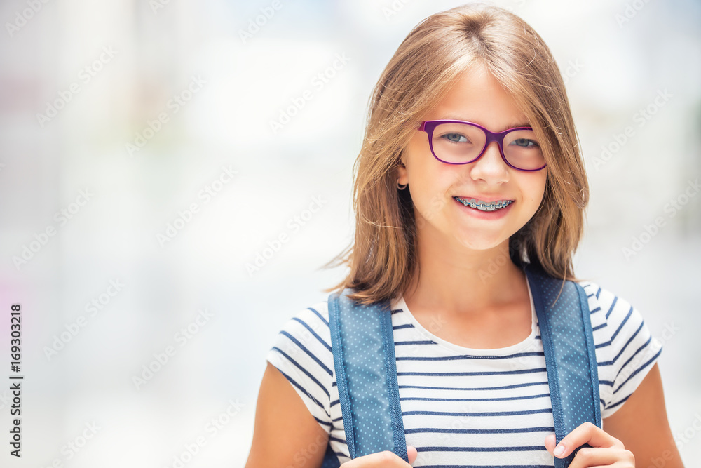 Schoolgirl with bag backpack. Portrait of modern happy teen