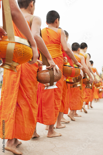 Monks processing for alms in the early morning, a 1,000-year old tradition in Luang Prabang, Laos..