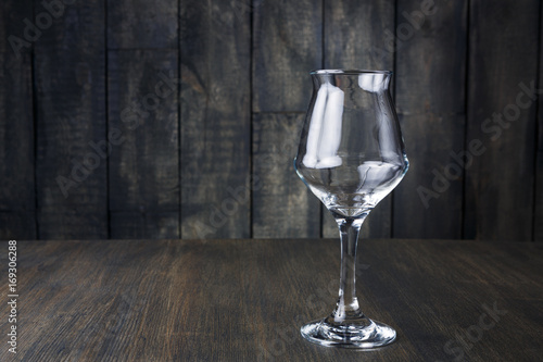 Empty glass on dark wooden background
