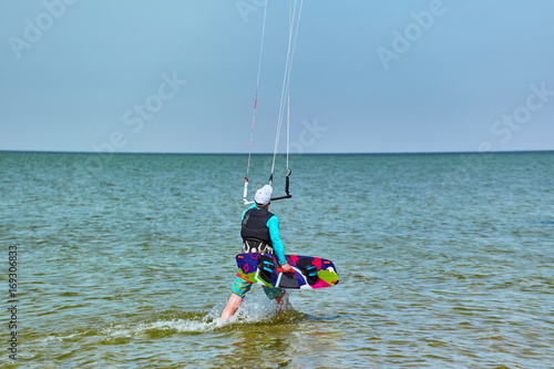 Kitesurfing on waves at sea in summer.