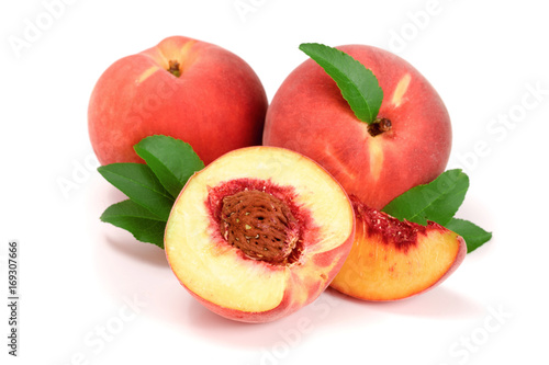 Peaches and half with green leaf isolated on white background