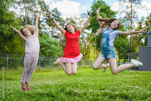 Children jumping on grass in park