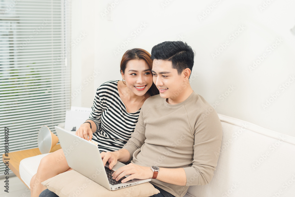 Happy asian couple in love surfing on tablet at home Happy asian couple in love surfing on tablet at home