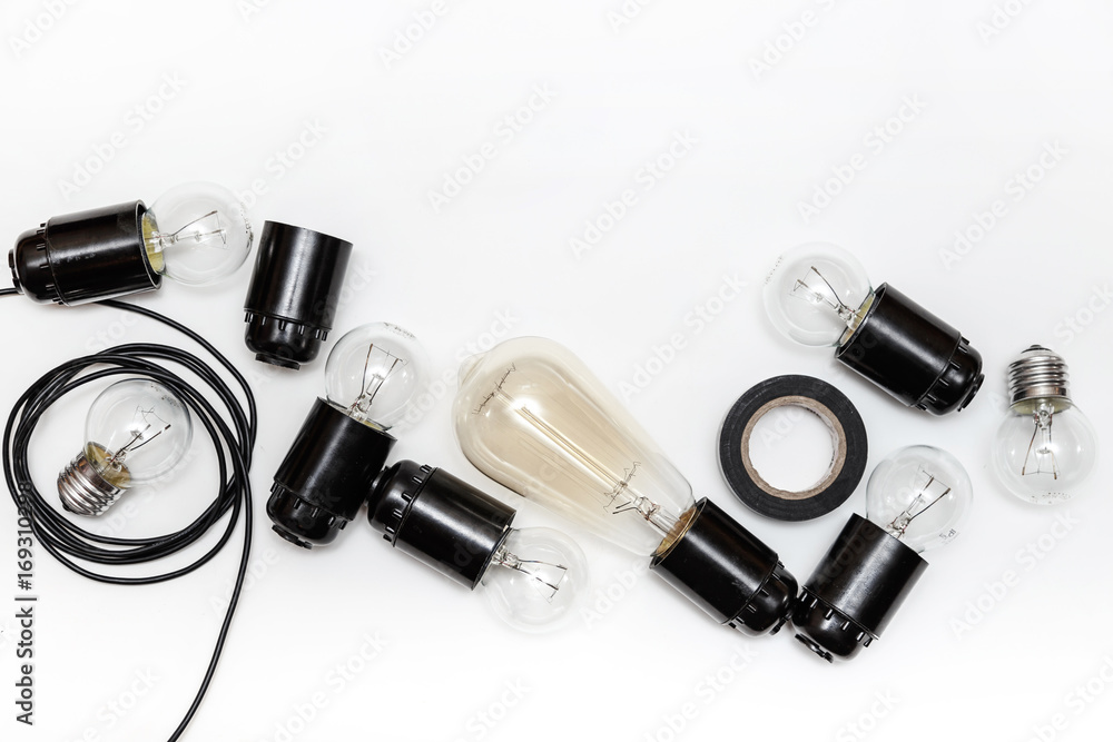 Retro light bulb, cartridges and wires for retro garlands on a white background isolated. Top view Retro light bulb, cartridges and wires for retro garlands on a white background isolated. Top view