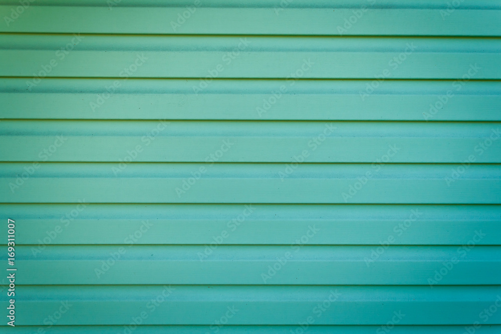 Fototapeta premium The green metal wall is goffered