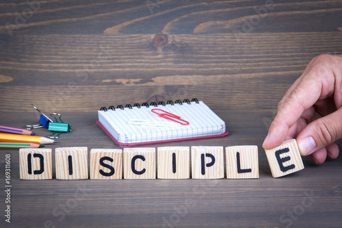 Disciple from wooden letters on dark texture background