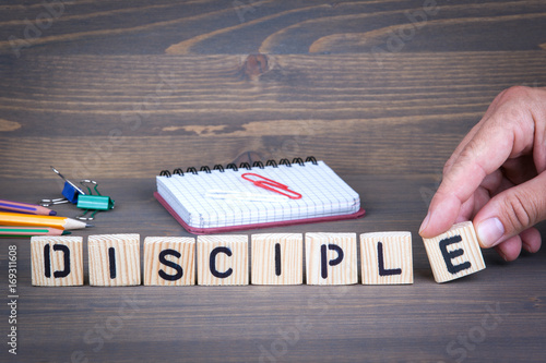 Quadro em tela Disciple from wooden letters on dark texture background