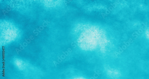 turquoise blue ink drop on wet white paper top view