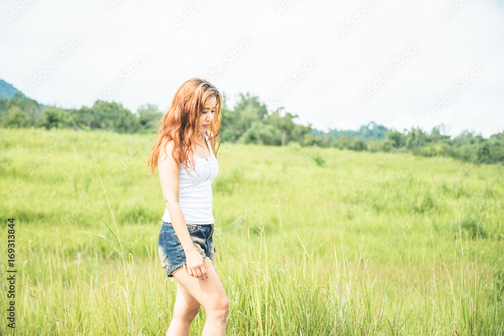 Asian women travel relax in the holiday. on a green pasture. Asian women travel relax in the holiday. on a green pasture.
