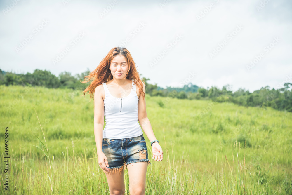 Asian women travel relax in the holiday. on a green pasture. Asian women travel relax in the holiday. on a green pasture.