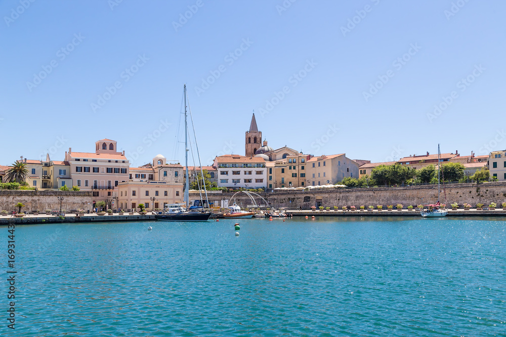 Alghero, Sardinia, Italy. Boats and yachts in the port against the walls of the fortress