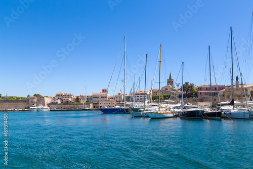 Alghero, Sardinia, Italy. Yachts in the port against the background of medieval fortress walls