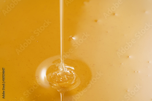 closeup of pouring organic honey with copy space