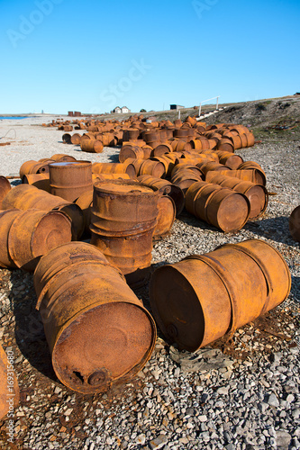 Rusted barrels on the shore, Chukotka, Russia