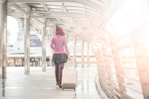 woman traveler walking with suitcase at airport corridor © saksit