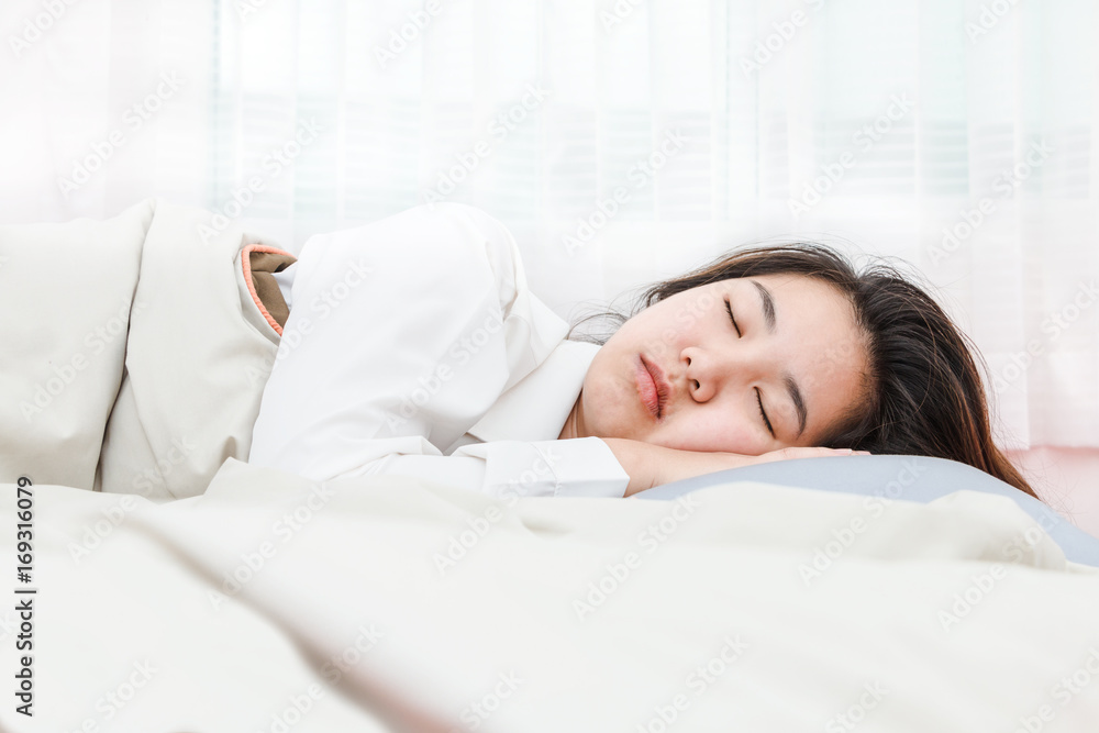 Young beautiful woman sleeping in her bed and relaxing in the morning Young beautiful woman sleeping in her bed and relaxing in the morning