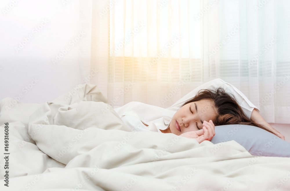 Young beautiful woman sleeping her bed and relaxing in the morning with sunray Young beautiful woman sleeping her bed and relaxing in the morning with sunray