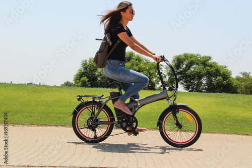 A women riding on electric e bike in the park