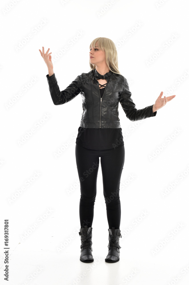 full length portrait of blonde girl wearing black leather outfit, standing pose on white background. full length portrait of blonde girl wearing black leather outfit, standing pose on white background.