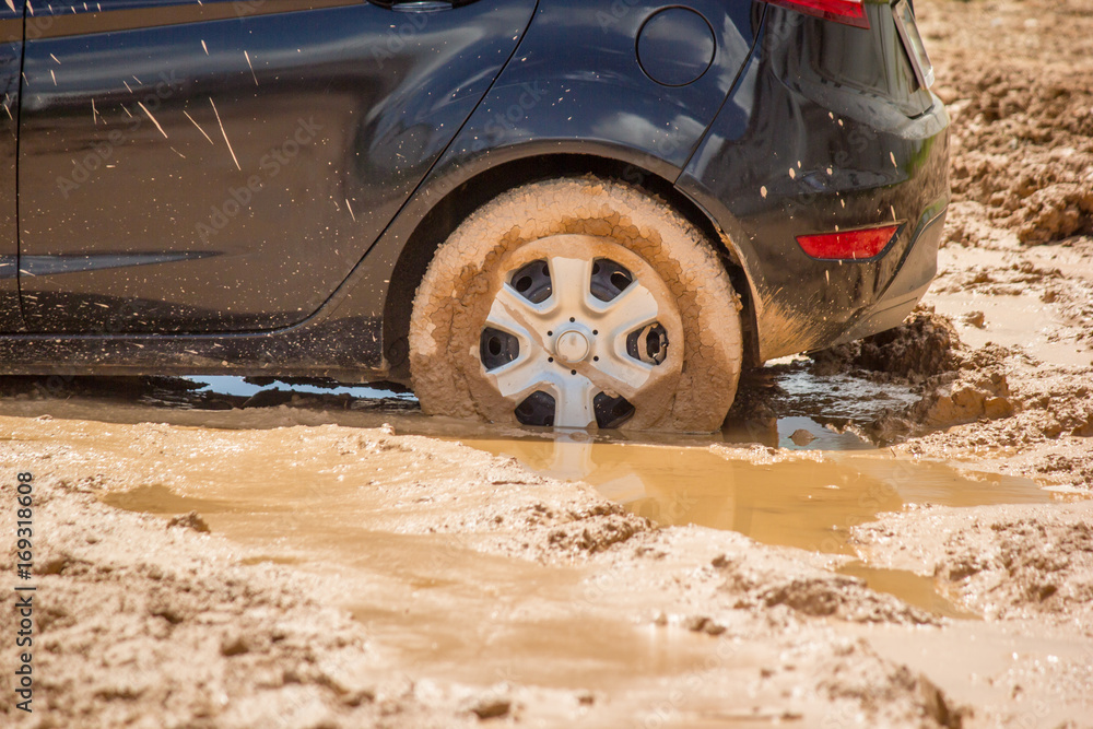 Car tire stuck in the mud background. Stock Photo Adobe Stock