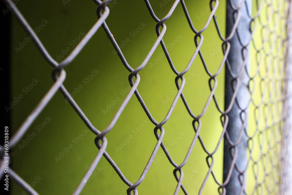 Close up metal chain-link fence pattern background. Close up metal chain-link fence pattern background.