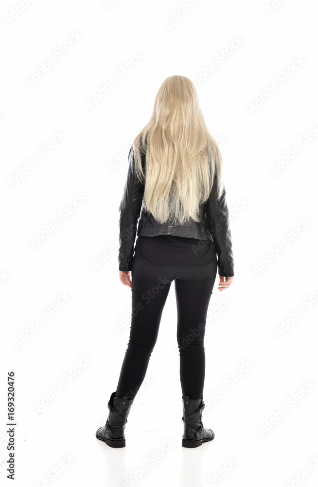 full length portrait of blonde girl wearing black leather outfit, standing pose on white background. full length portrait of blonde girl wearing black leather outfit, standing pose on white background.