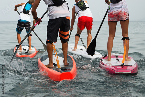 Stand up paddle group on the sea photo