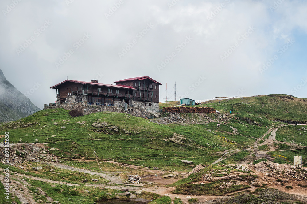 Mountain landscape, house on the hill in Carpathians, Romania Mountain landscape, house on the hill in Carpathians, Romania