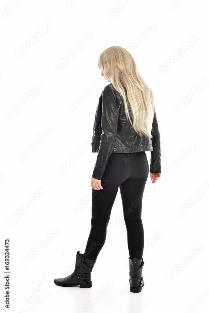 full length portrait of blonde girl wearing black leather outfit, standing pose on white background. full length portrait of blonde girl wearing black leather outfit, standing pose on white background.