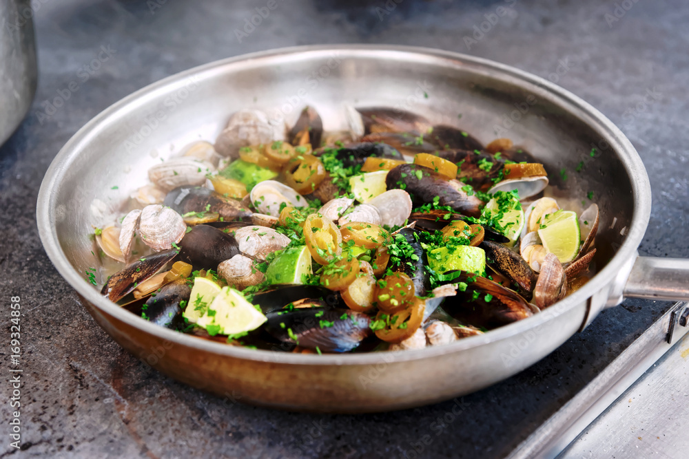 Clams and mussels on hot pan, toned Clams and mussels on hot pan, toned