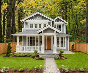 Beautiful, Newly Built Luxury Home Exterior with Lush Forest in Background