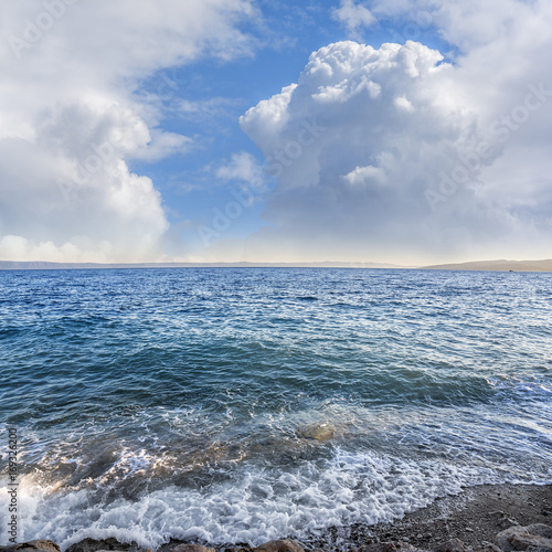 Blue sky with clouds over the sea. © Denis Rozhnovsky