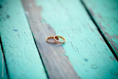 Wedding rings on an old wooden background