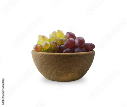 Grapes in a wooden bowl isolated on white background. Green grapes Kish Mish.
