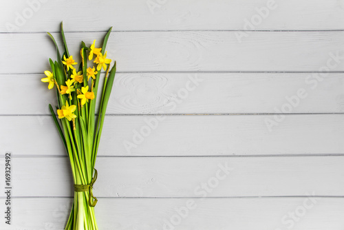 Bouquet of daffodils on grey background. Romantic minimalistic spring composition  top view  flat lay