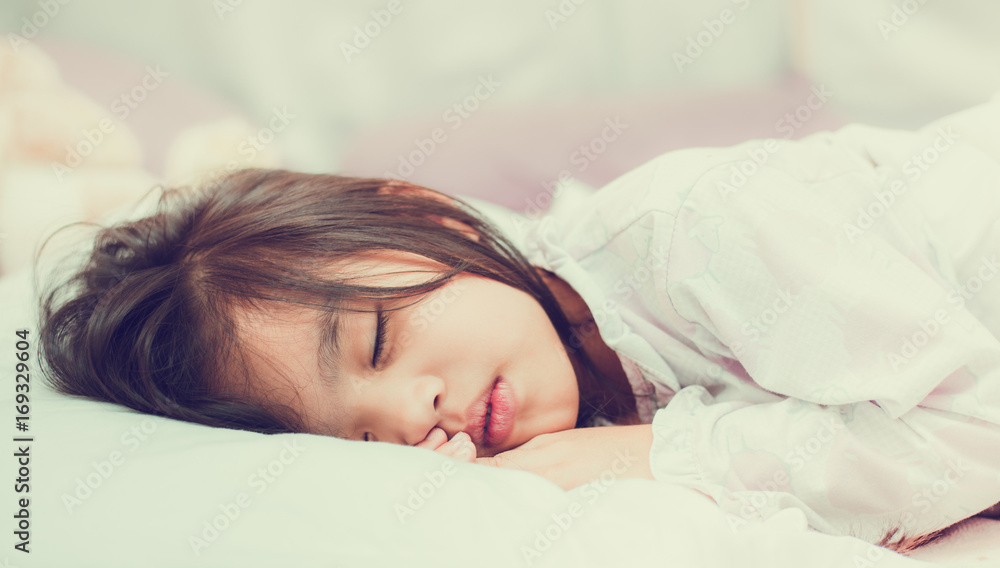 Sweet little girl is sleeping in bed at home Sweet little girl is sleeping in bed at home