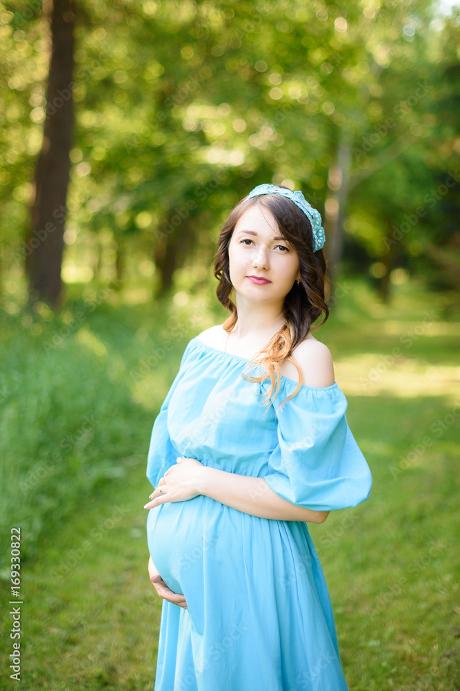 pregnancy, motherhood, people and expectation concept - close up of happy pregnant woman with big belly in park pregnancy, motherhood, people and expectation concept - close up of happy pregnant woman with big belly in park