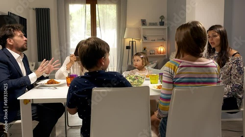 Father getting angry with children at the table