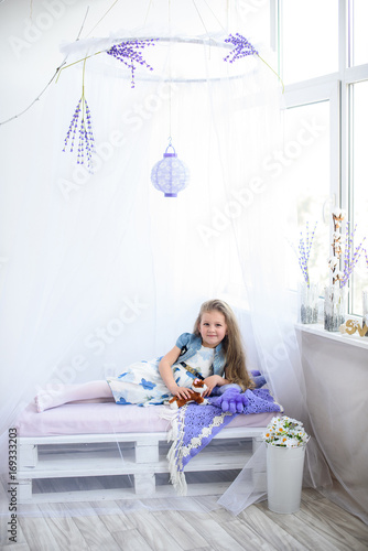 Cute little girl at home at window