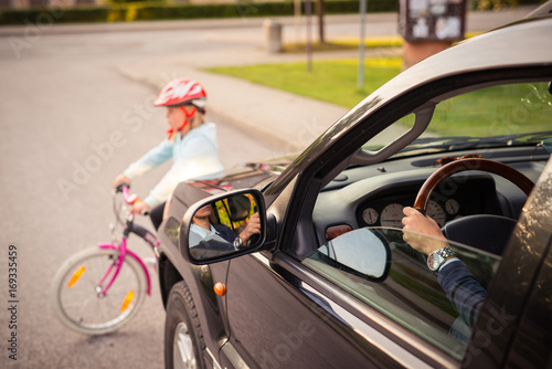 Accident. Girl on the bicycle crosses the road in front of a car