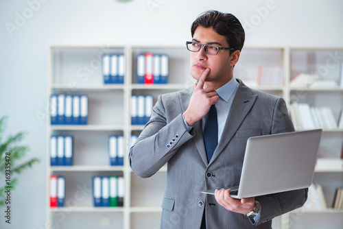 Businessman with laptop in the office